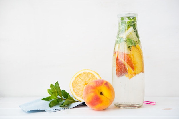 Premium Photo Homemade Detox Lemonade With Lemon And Peach In A Bottle