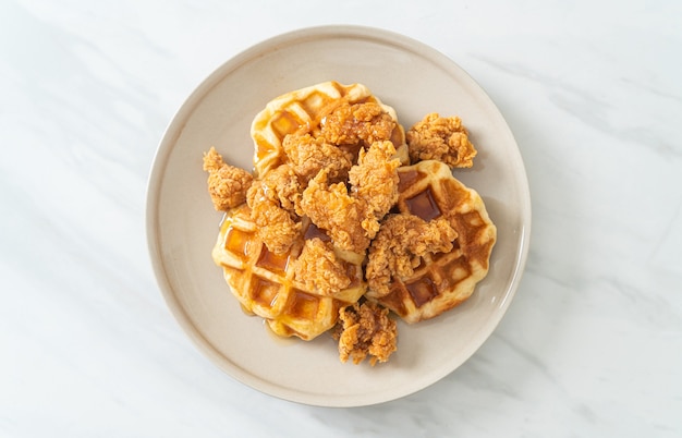 Premium Photo | Homemade fried chicken waffle with honey or maple syrup