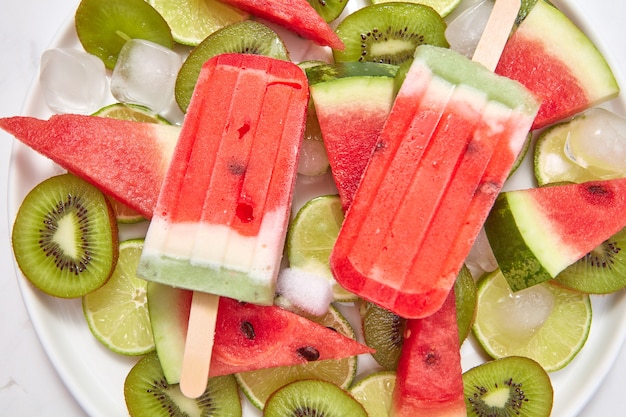 Premium Photo | Homemade ice cream on a stick with a piece of fruits