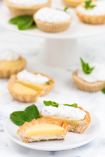 Premium Photo | Homemade Lemon Curd Tartlets With Meringue, Mint Leaves ...