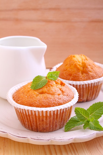 Premium Photo | Homemade muffins decorated mint with cup of tea