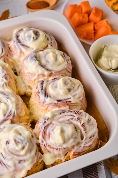 Premium Photo Homemade Pumpkin Cinnamon Rolls With Cream Cheese In A