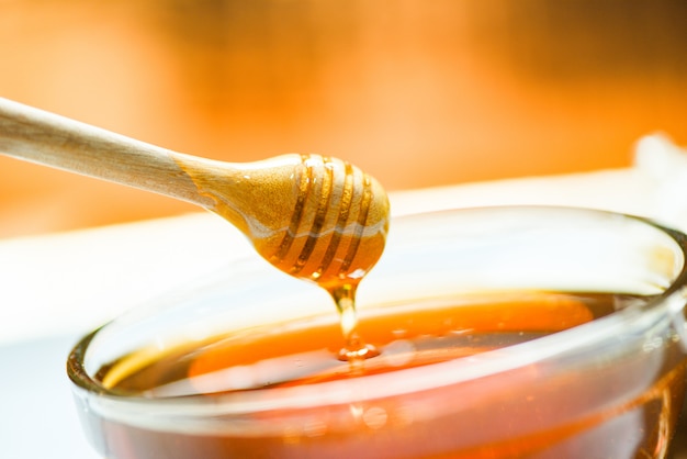 Premium Photo | Honey dripping on honey jar