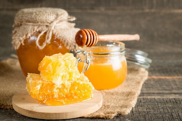Premium Photo | Honey in a jar on wooden rustic background