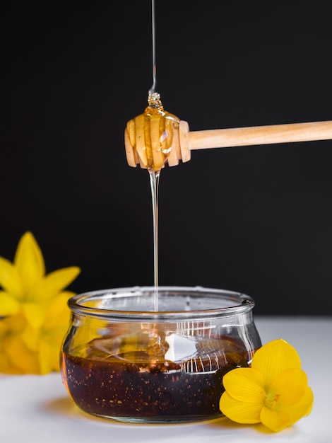 Free Photo | Honey pouring on dipper front view