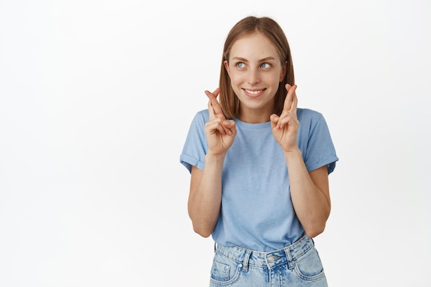 Premium Photo | Hopeful and excited girl student, wishing, hold fingers ...