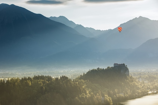 Premium Photo | Hot air balloon floating over the mountains. landscape