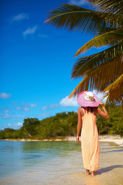 Free Photo | Hot beautiful woman in colorful sunhat and dress walking ...