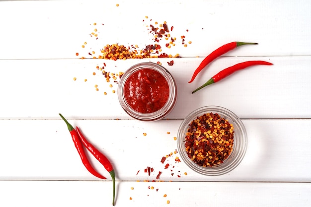 Download Premium Photo Hot Chilli Pepper Sauce Paste Harissa Traditional Tunisia Moroccan Arabic Cuisine Adjika Chili Pepper Spices And Fresh Red Chilli Peppers Over White Wooden Table Flat Lay