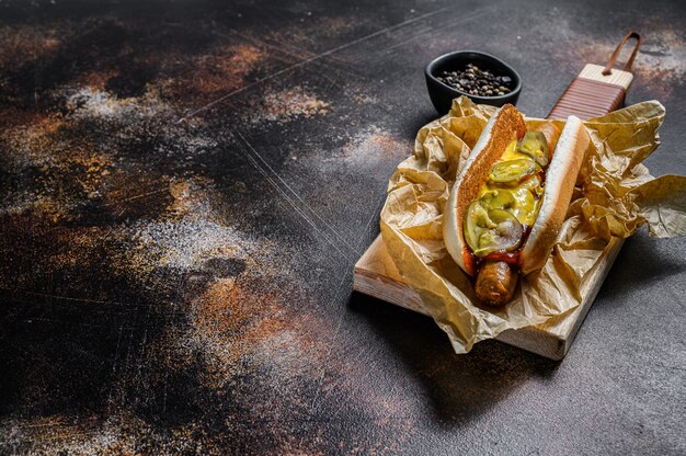 Download Premium Photo Hot Dog With Chicken Sausage On A Wooden Cutting Board In Kraft Paper Fast Food Restaurant Menu Concept Junk Food Space For Text