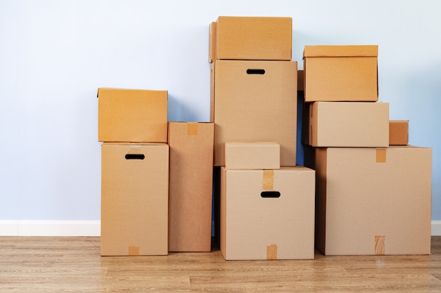 Premium Photo | House moving concept with stacked cardboard boxes in a room