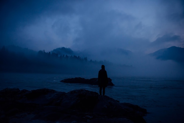 Premium Photo | Human silhouette in a thick blue fog on the background ...