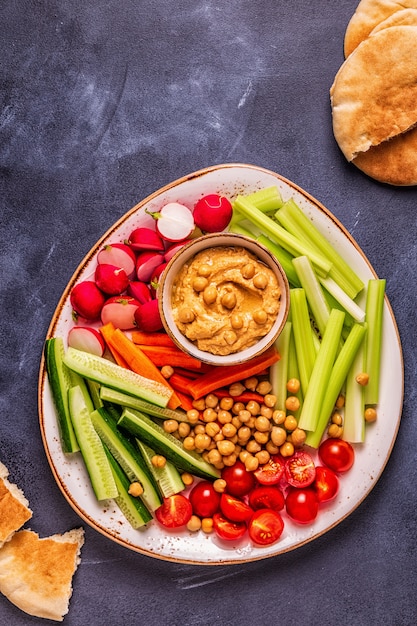 Premium Photo | Hummus with various fresh raw vegetables.