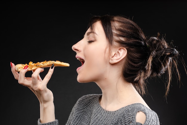 Hungry Girl With Opened Mouth Eating Pizza Premium Photo