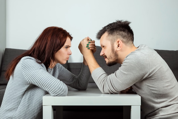 https://image.freepik.com/free-photo/husband-and-wife-are-fighting-in-their-arms-arm-wrestling-between-male-and-female-family-quarrel-showdown-division-of-property-divorce-the-struggle-between-women-and-men_99433-528.jpg