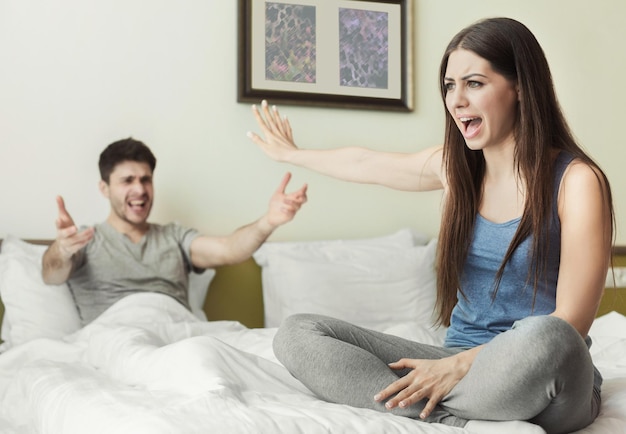 Premium Photo Husband And Wife Arguing And Shoutng On Each Other Sitting On The Bed