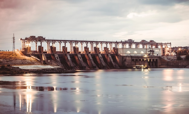 Premium Photo | Hydro power station on river at sunset