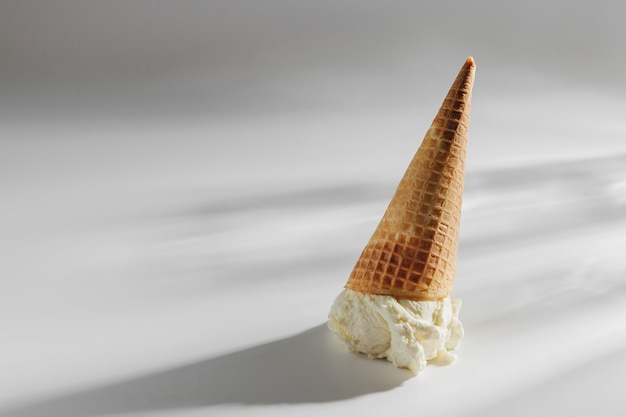 Premium Photo | Ice cream cone fallen on white background.