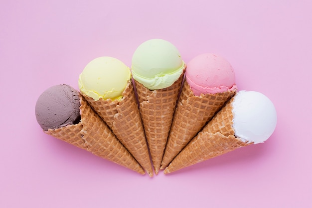 Ice cream cones on pink table Free Photo