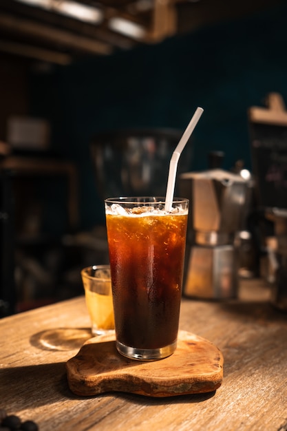 Premium Photo | Iced americano coffee in a glass on a bar in a cafe.