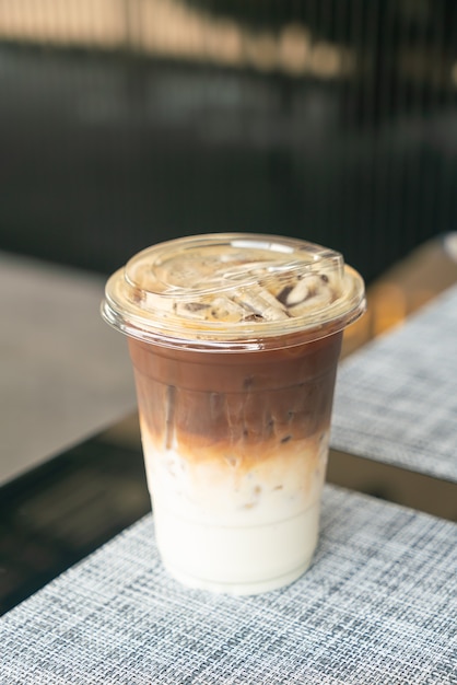 Premium Photo | Iced latte coffee cup on table in cafe coffee shop