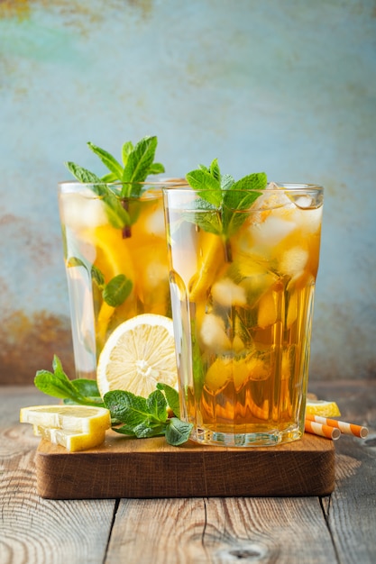 Premium Photo | Iced tea with lemon and ice in tall glasses.