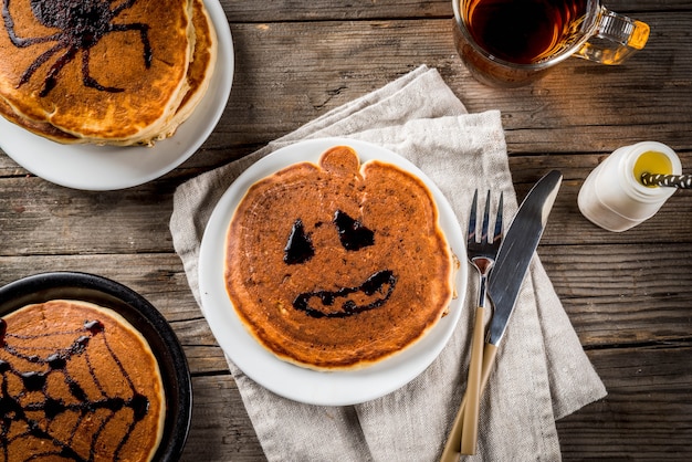 Premium Photo Ideas For Breakfast Are Halloween Food For Children Pumpkin Pie Pancakes Decorated With Chocolate Syrup In A Traditional Style Spider Web Spider Jack Lantern On Wooden Rustic Table