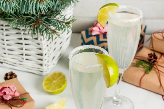 Premium Photo Ideas For Christmas And New Year Drinks Champagne Margarita Cocktails Garnished With Lime And Salt On White Table With Xmas Decorations Copyspace