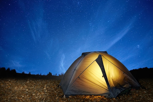 Premium Photo | Illuminated yellow camping tent under stars at night