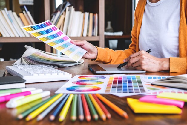 Image of graphic designer working on color selection and drawing on graphics tablet Premium Photo
