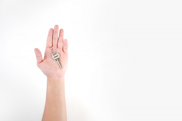 The image in the hands of asian people has keys on a white background. Premium Photo