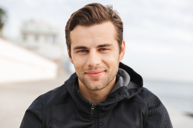 Premium Photo | Image of handsome man 30s in black sportswear, while ...