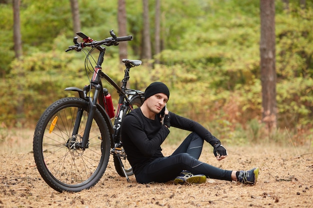 Premium Photo | Image of male mountain biker resting on cycling trip ...