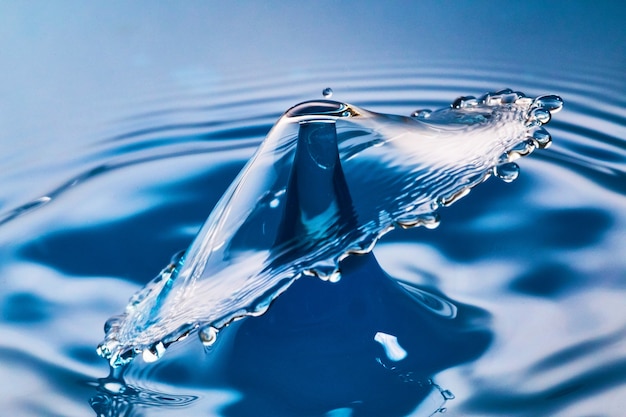 Premium Photo | Image of two water drops colliding on blue water with ...