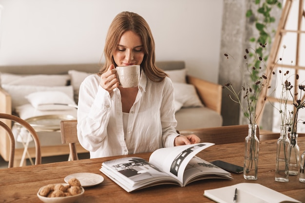 Premium Photo | Image of young cute beautiful lady sit indoors in ...