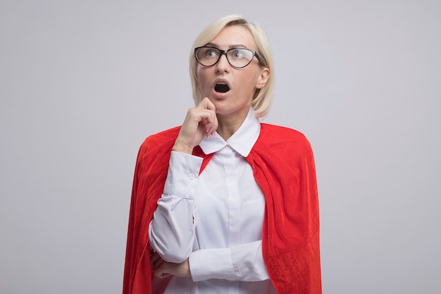 Free Photo Impressed Middle Aged Blonde Superhero Woman In Red Cape