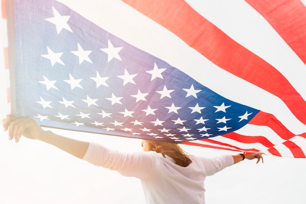 Free Photo | Independence day concept with woman holding flag on sky ...