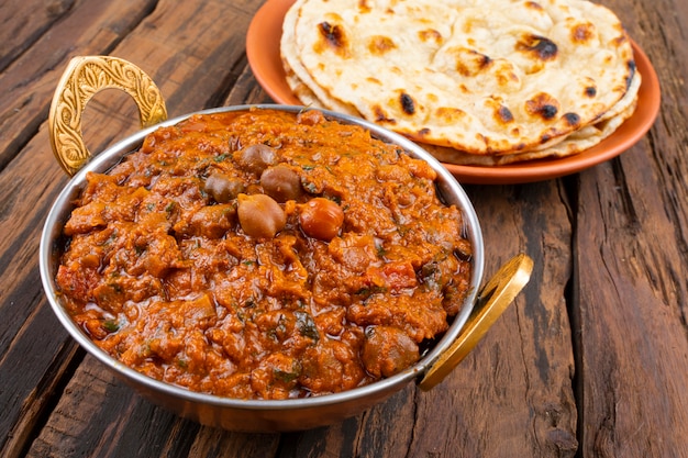 Premium Photo | Indian cuisine chana masala served with tandoori roti ...