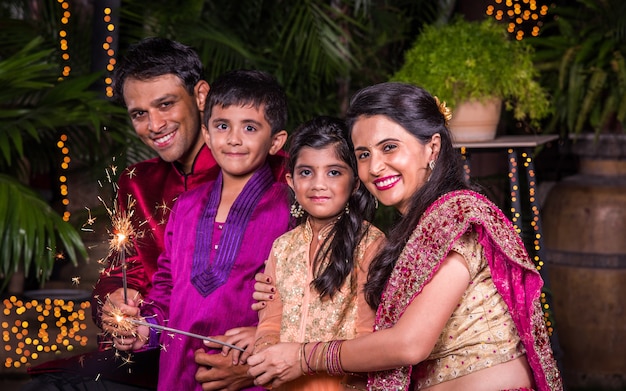 Premium Photo | Indian family in traditional wear playing with ...