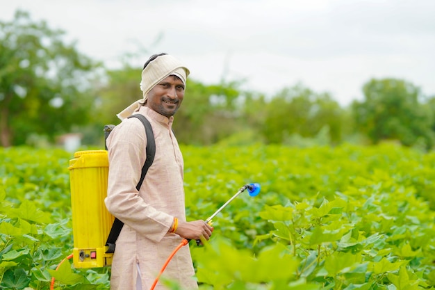 Premium Photo | Indian farmer spraying pesticide at cotton field.