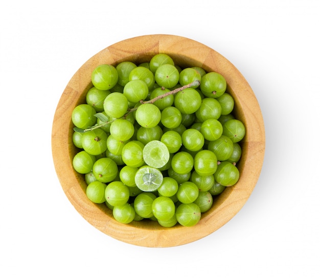 Premium Photo | Indian gooseberry in wood bowl on white wall.