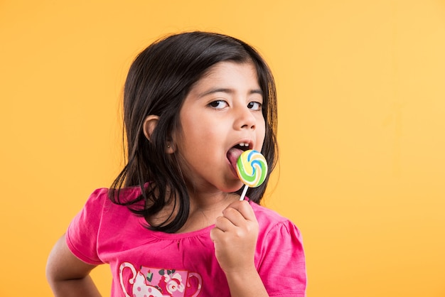 Premium Photo | Indian small girl with lolipop or loly pop, asian girl ...