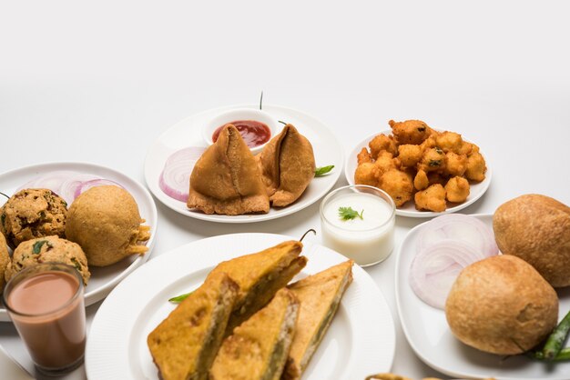 Premium Photo | Indian tea time snacks in group includes veg samosa ...