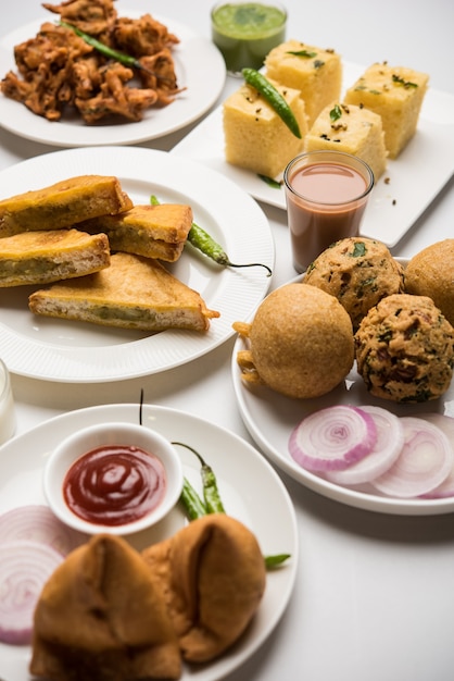 Premium Photo | Indian tea time snacks in group includes veg samosa ...