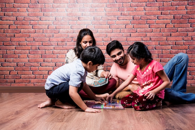 premium-photo-indian-young-family-of-four-playing-board-games-like