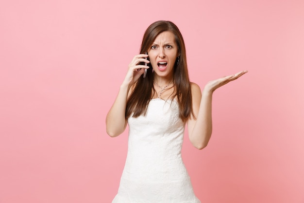 Premium Photo Indignant Woman In White Dress Talking On Mobile Phone