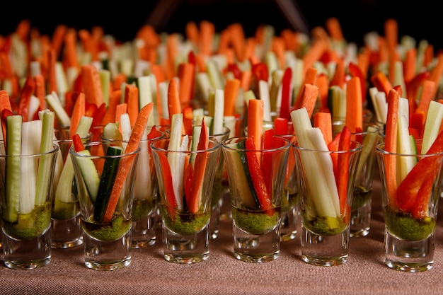 Premium Photo Individual Cocktail Shot Glasses With Sticks Of Carrot Cucumber And Spicy Sauce