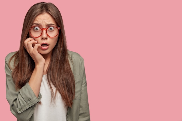 free-photo-indoor-shot-of-astounded-student-posing-against-the-pink-wall