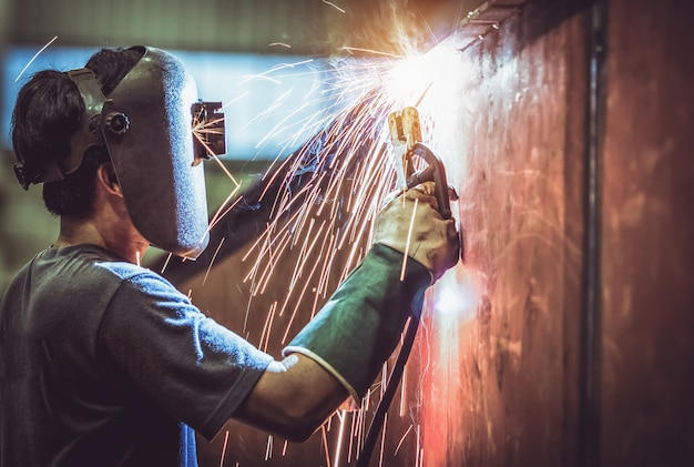 Premium Photo | Industrial worker labourer at the factory welding steel ...