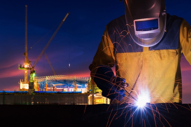 Industrial worker welding steel structure for infrastructure building project Premium Photo